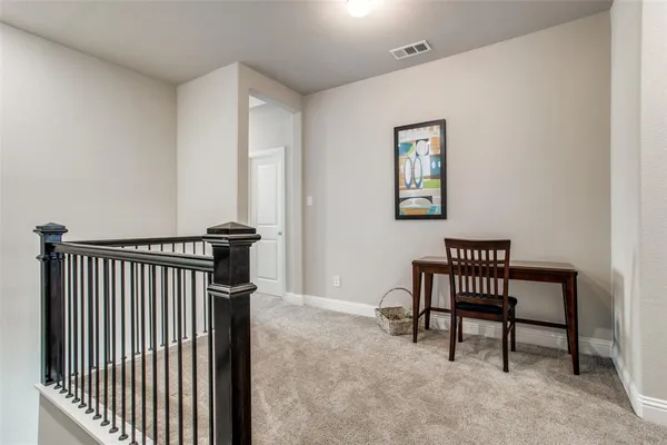 a view of a hallway with seating area