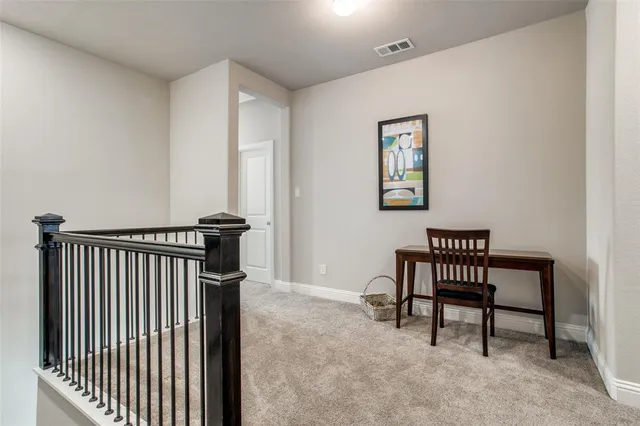 a view of a hallway with seating area