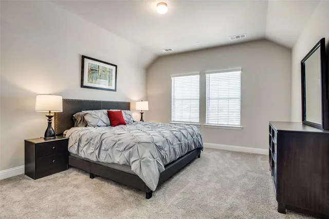 a spacious bedroom with a bed and a window