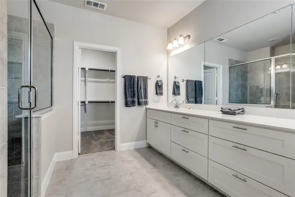 a spacious bathroom with a granite countertop sink mirror and shower