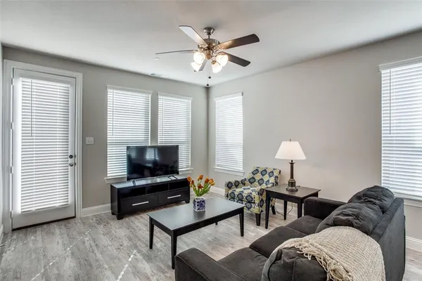 a living room with furniture a window and a flat screen tv