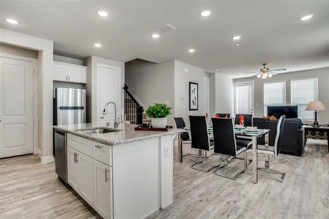 a kitchen with counter top space and wooden floor