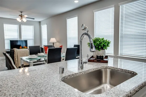 a kitchen with a table chairs in it and living room