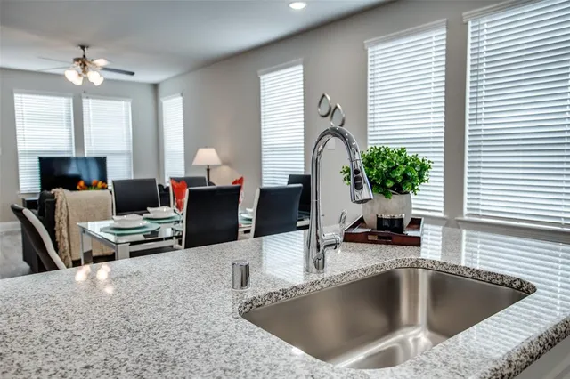 a kitchen with a table chairs in it and living room