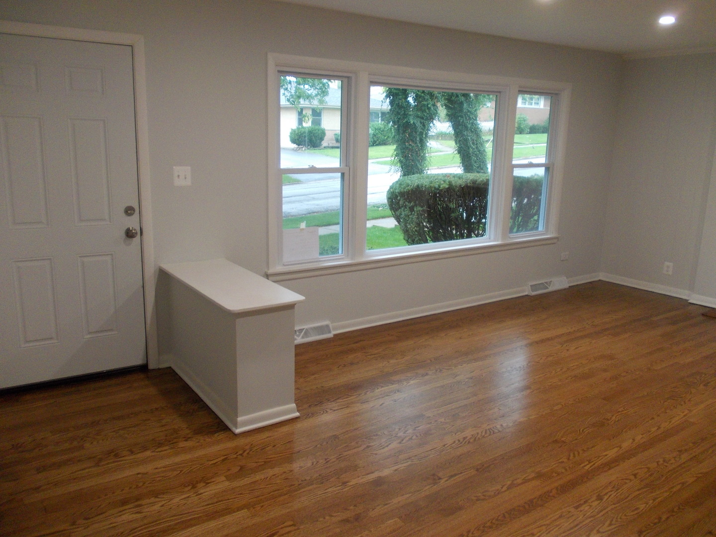 1418 Hillview Road Homewood, IL 60430 - Photo 2 of 19 a view of an empty room with wooden floor and a window