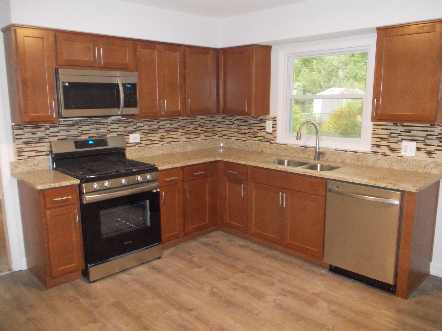 1418 Hillview Road Homewood, IL 60430 - Photo 7 of 19 a kitchen with sink a microwave a stove and cabinets