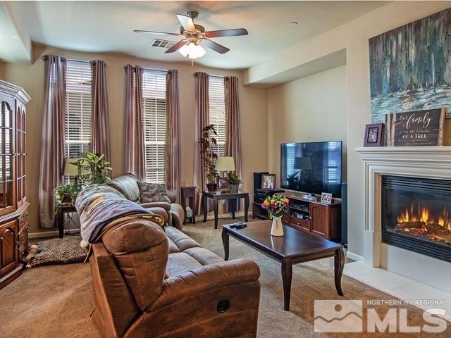 1915 Wind Ranch Road, Unit C Reno, NV 89521 - Photo 4 of 15 a living room with furniture a fireplace and a flat screen tv