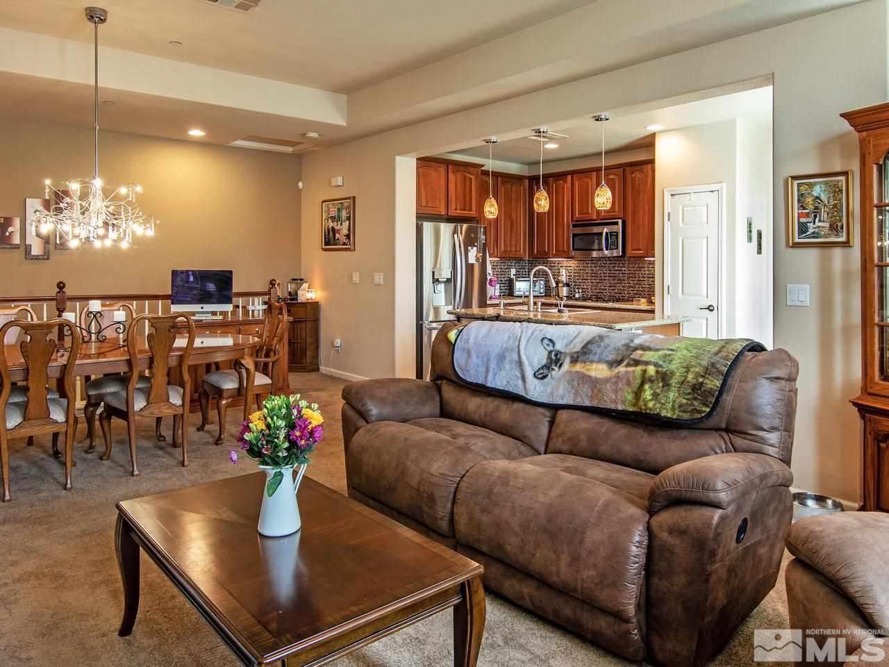 1915 Wind Ranch Road, Unit C Reno, NV 89521 - Photo 5 of 15 a living room with furniture and a chandelier