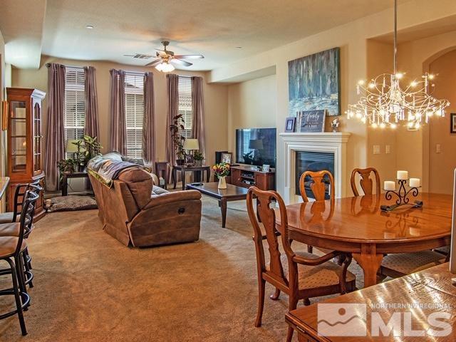 1915 Wind Ranch Road, Unit C Reno, NV 89521 - Photo 6 of 15 a living room with fireplace furniture and a large window