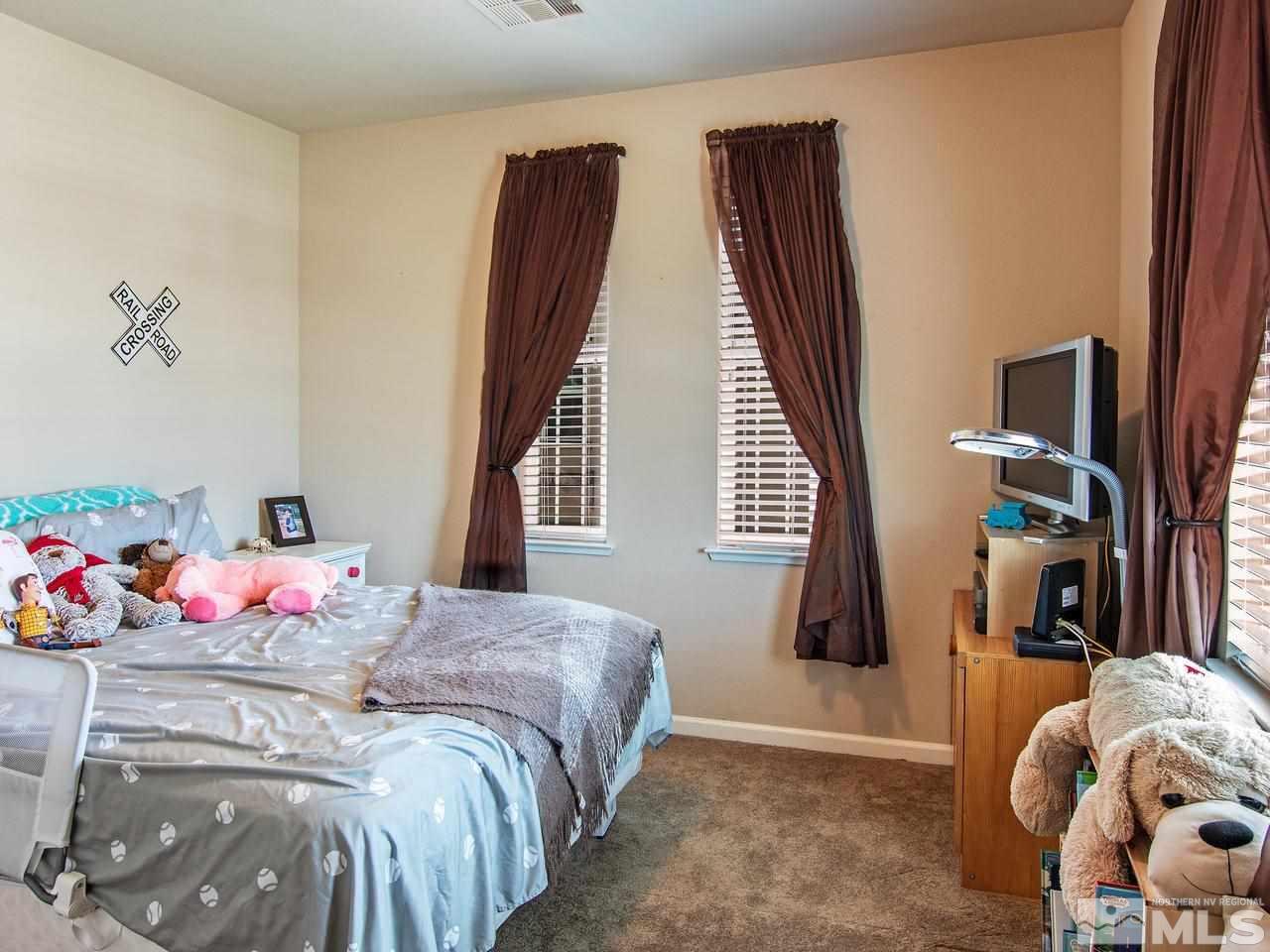 1915 Wind Ranch Road, Unit C Reno, NV 89521 - Photo 9 of 15 a bedroom with a bed and a window
