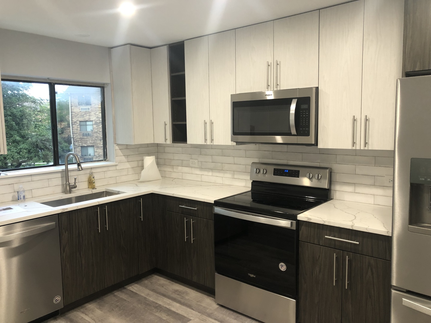 2243 West Nichols Road, Unit C Arlington Heights, IL 60004 - Photo 2 of 10 a kitchen with a sink a stove and microwave