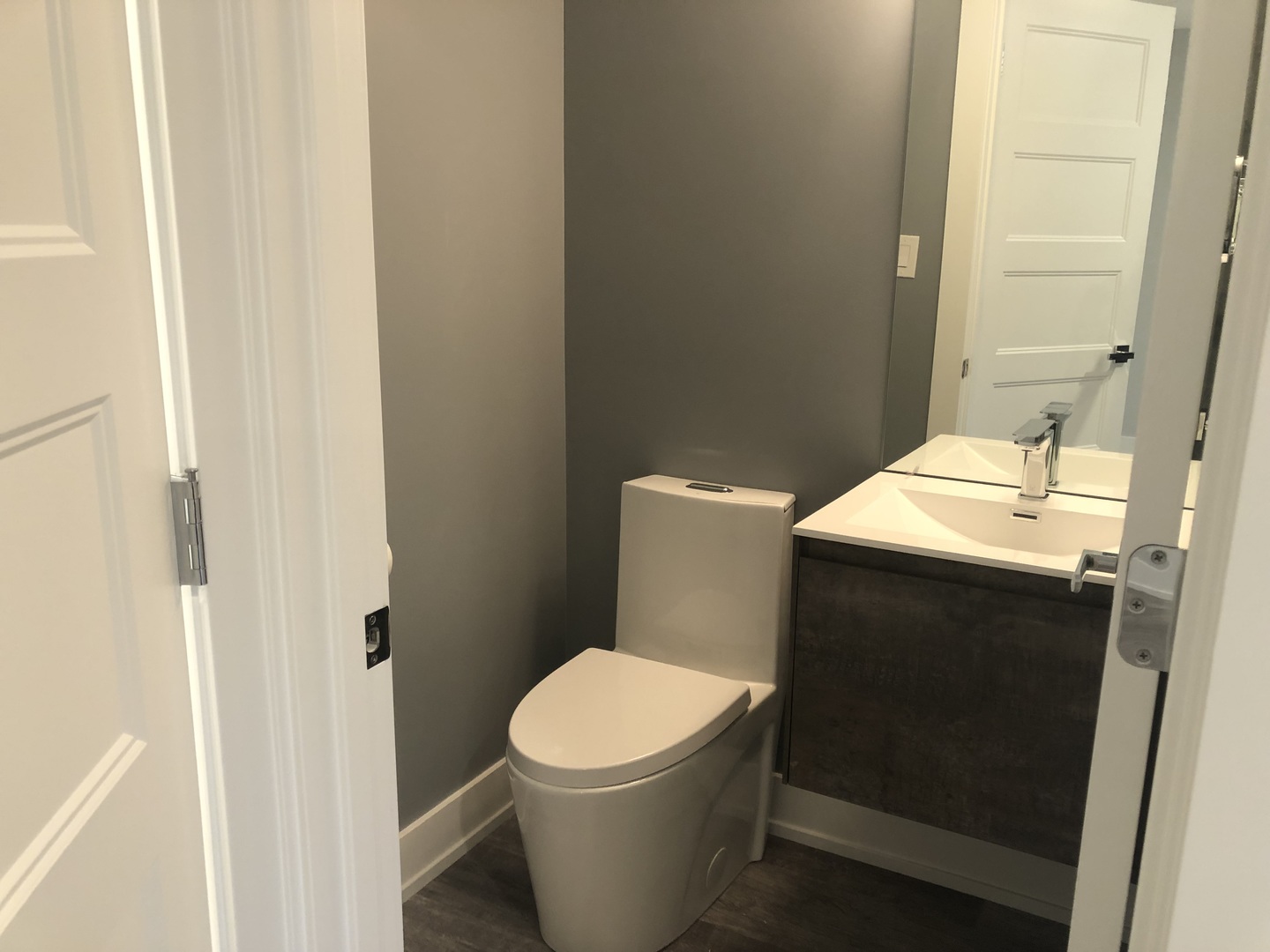 2243 West Nichols Road, Unit C Arlington Heights, IL 60004 - Photo 6 of 10 a white toilet sitting next to a bathroom sink