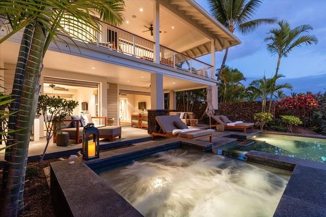 a living room with patio furniture and a potted plant