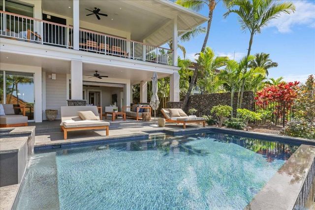 a view of a patio with couches and a potted plant on a table and chairs