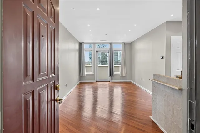 a view of an entryway with wooden floor