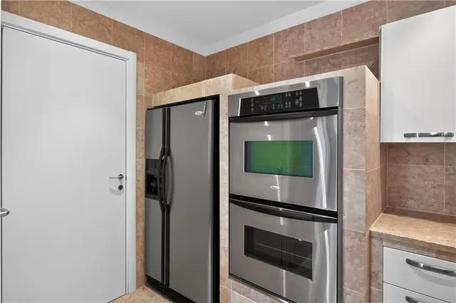 a kitchen with stainless steel appliances a refrigerator and a stove