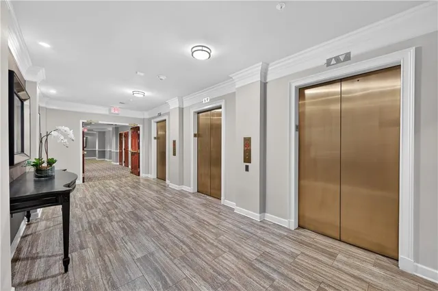 a view of hallway with livingroom and wooden floor