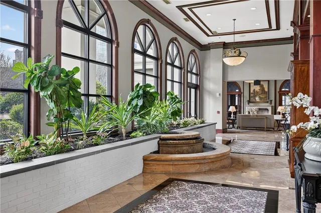 a front view of a house with plants and outdoor seating