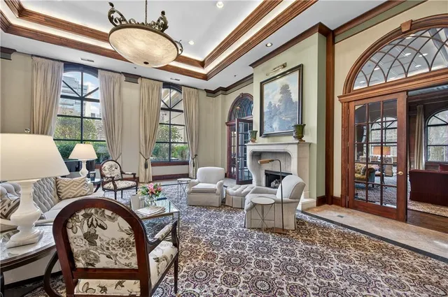 a living room with fireplace furniture and a large window