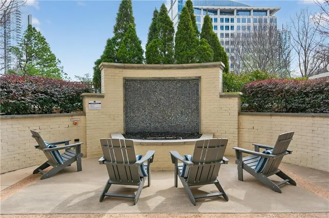 a view of patio with table and chairs and potted plants