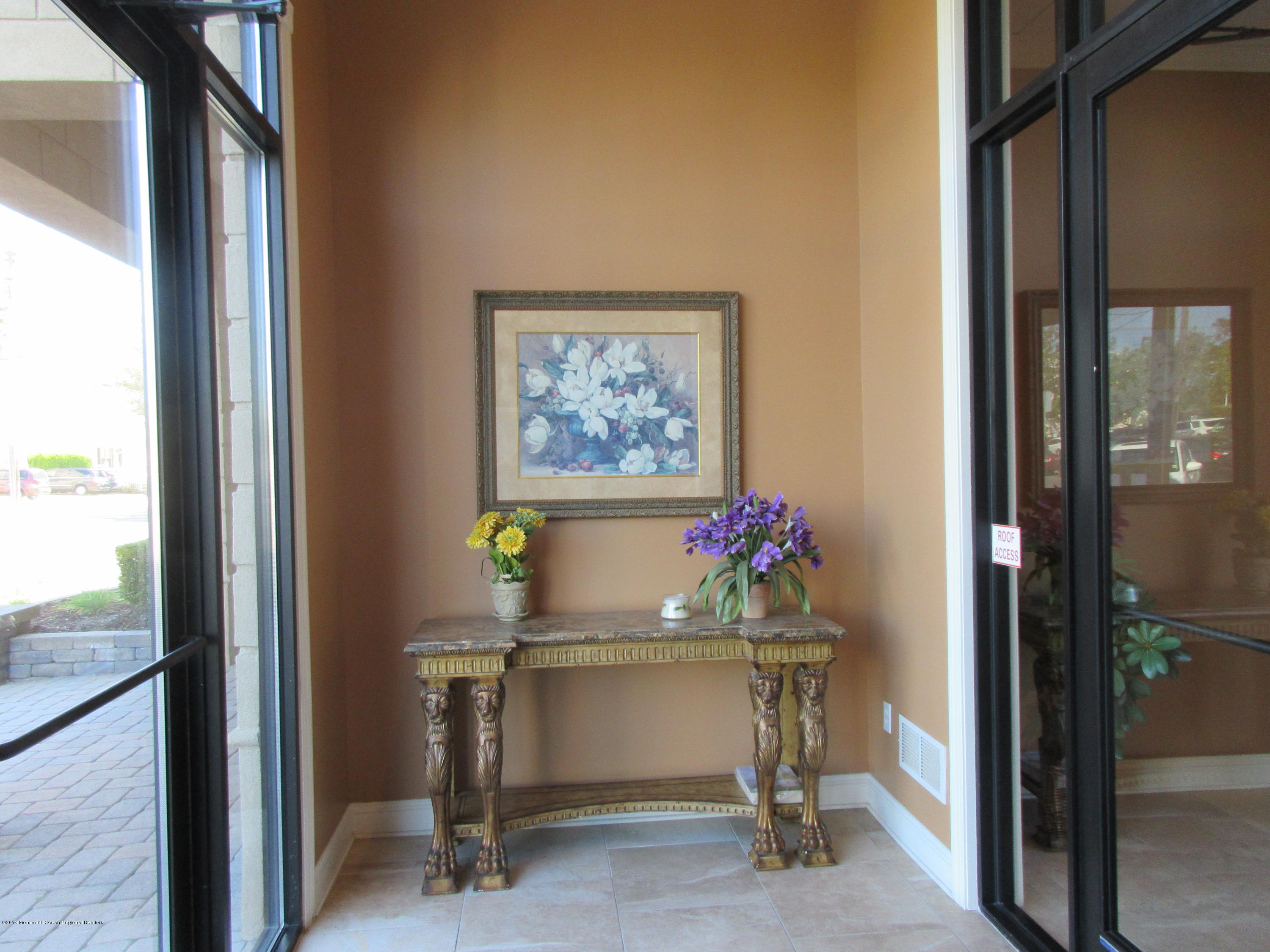 701 Main Street, Unit 301 Belmar, NJ 07719 - Photo 2 of 13 a view of entryway with a flower pot and a bookshelf