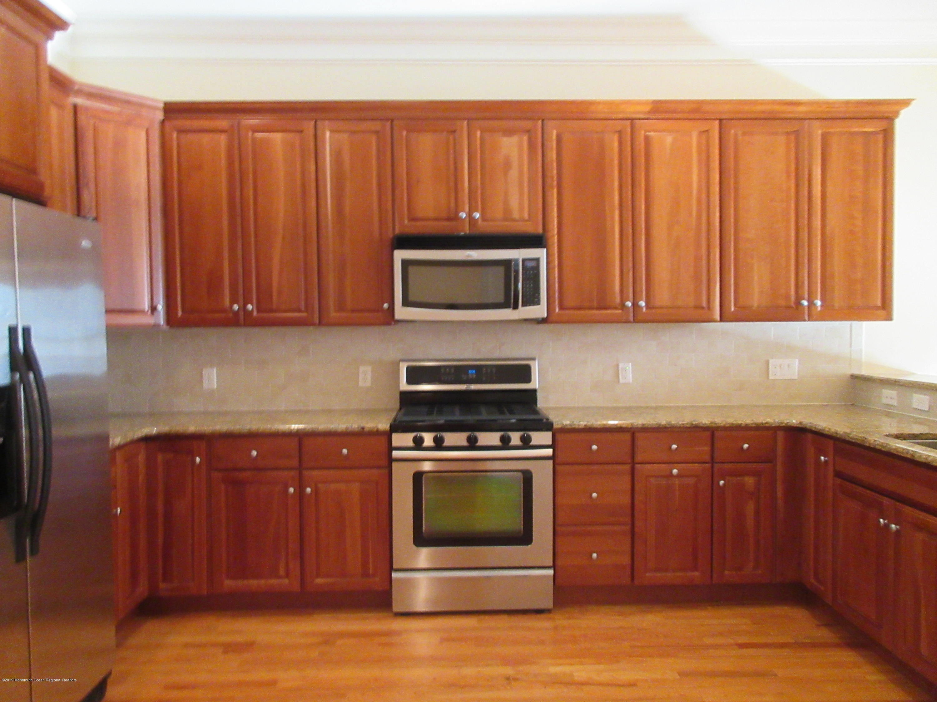 701 Main Street, Unit 301 Belmar, NJ 07719 - Photo 5 of 13 a kitchen with a stove and a microwave