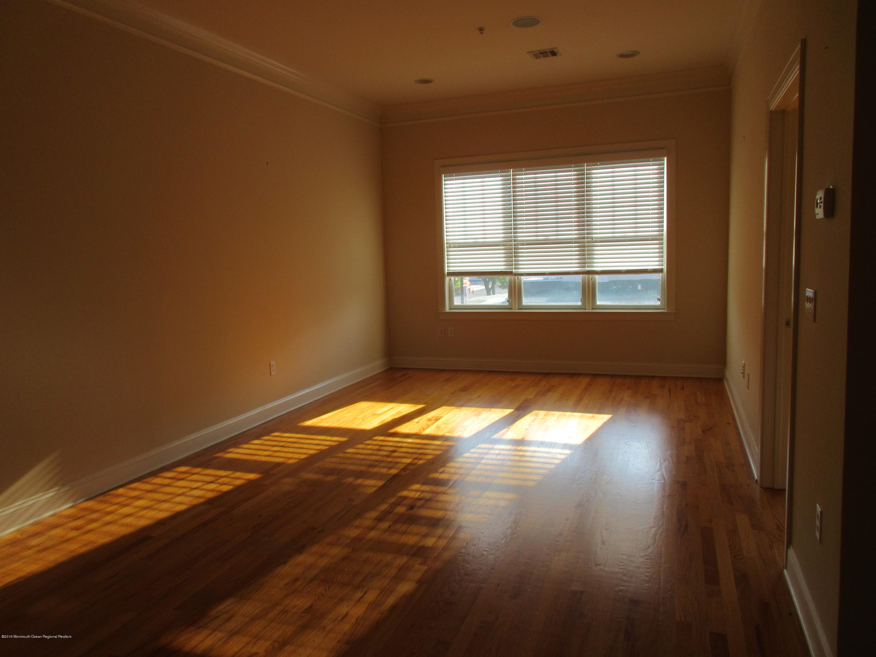701 Main Street, Unit 301 Belmar, NJ 07719 - Photo 7 of 13 a view of empty room with wooden floor and fan