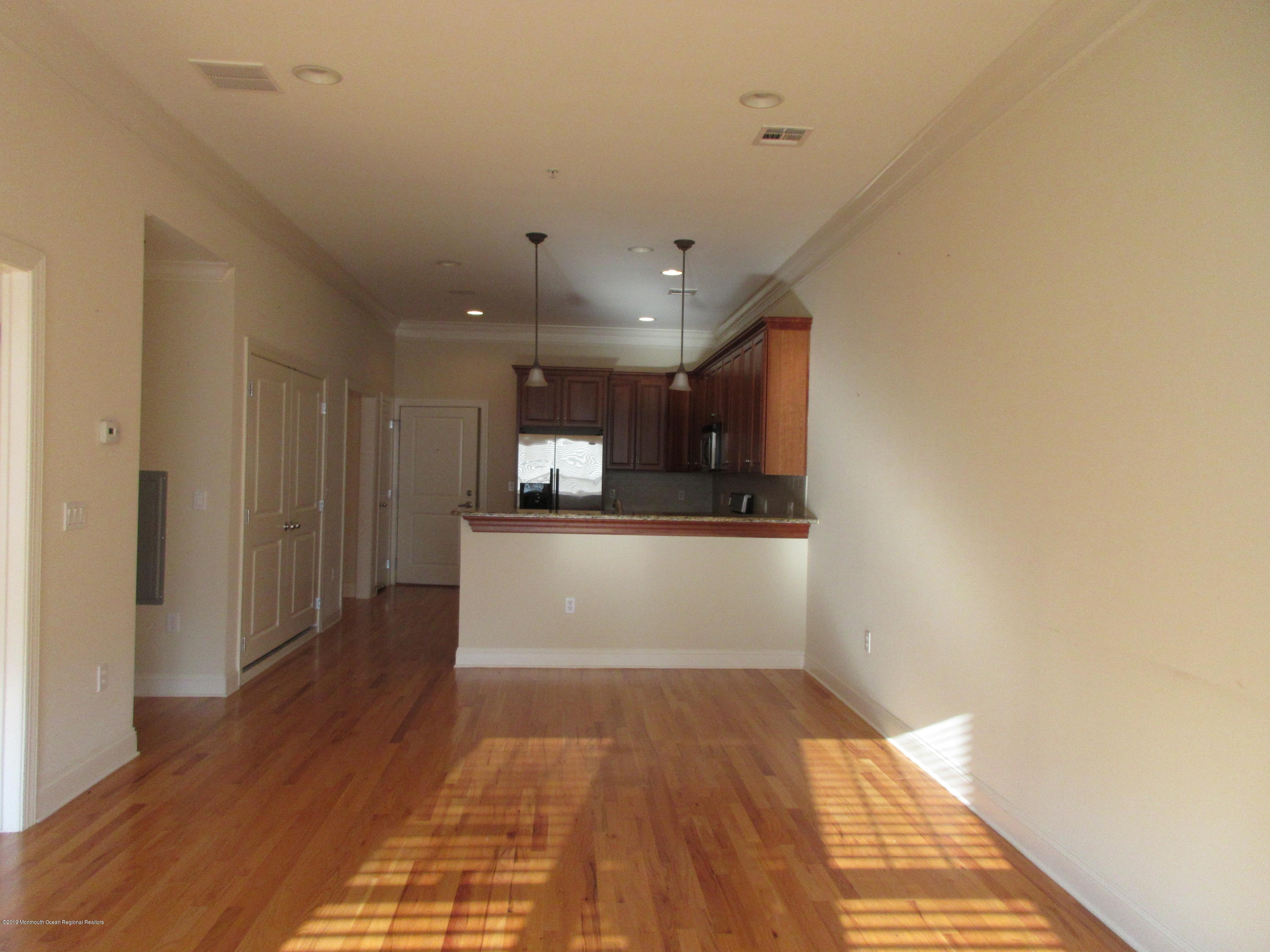 701 Main Street, Unit 301 Belmar, NJ 07719 - Photo 8 of 13 a view of a hallway with wooden floor