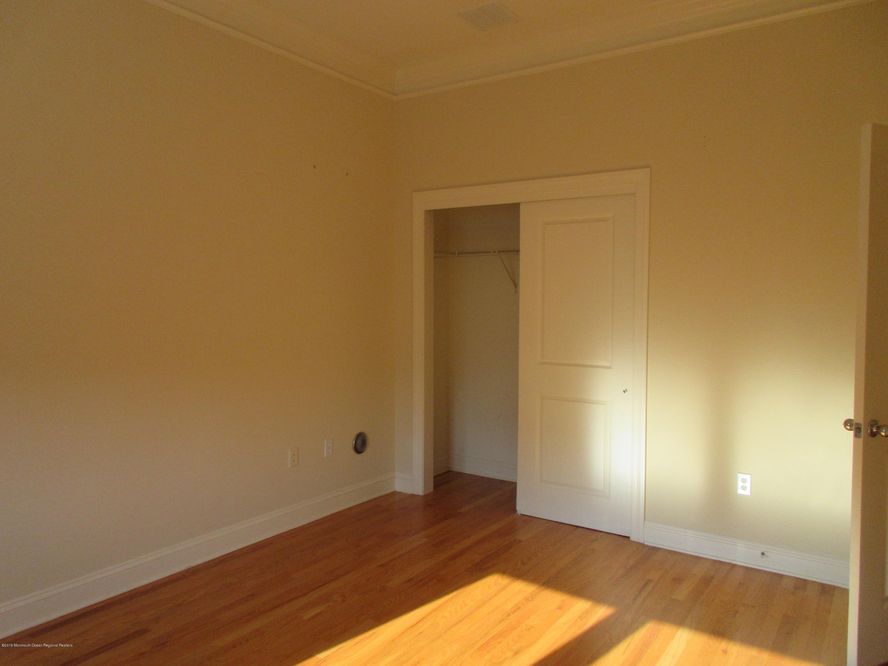 701 Main Street, Unit 301 Belmar, NJ 07719 - Photo 10 of 13 a view of an empty room and wooden floor
