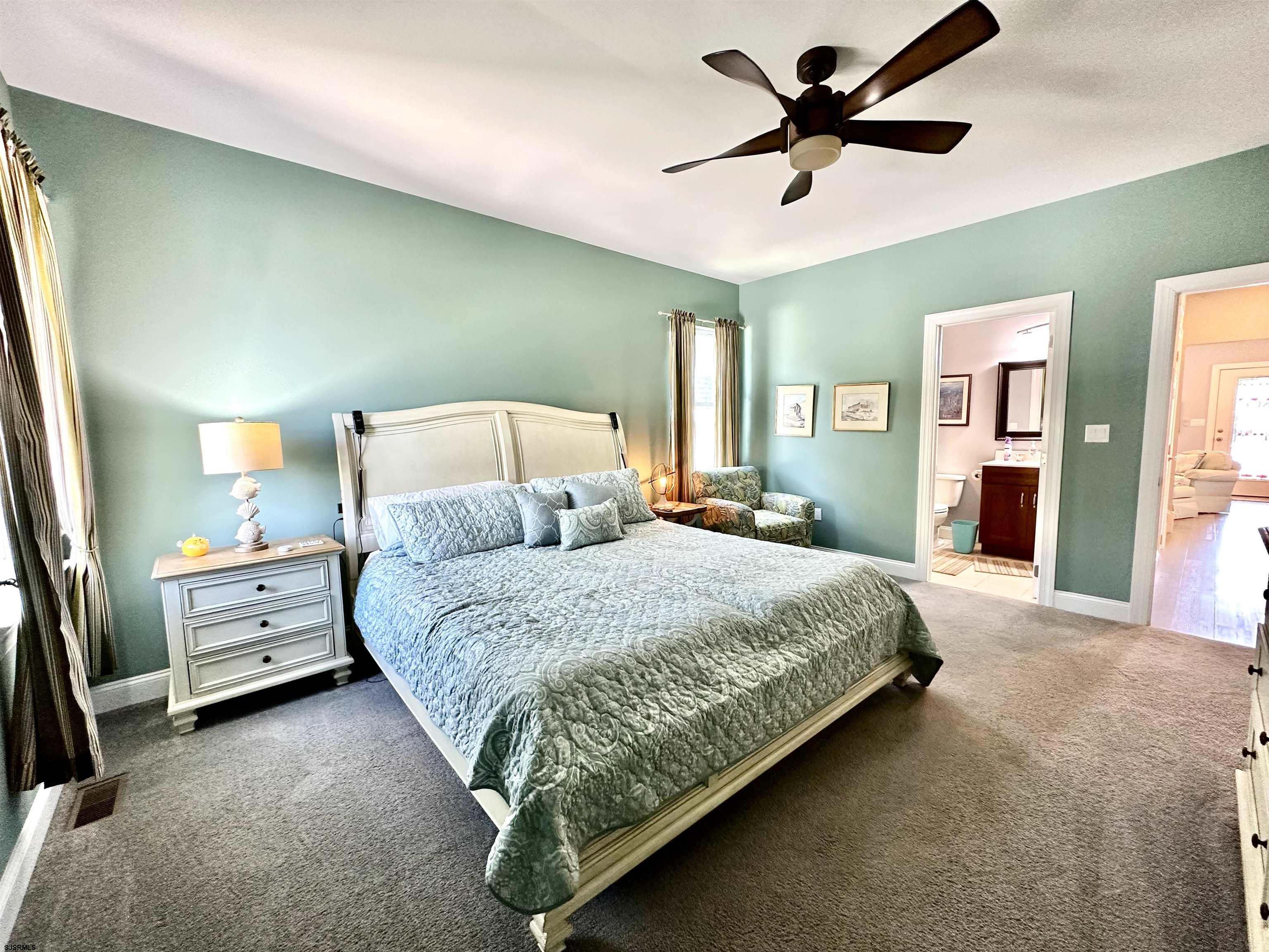 201 19th Street South Brigantine, NJ 08203 - Photo 13 of 29 a spacious bedroom with a bed and a chandelier