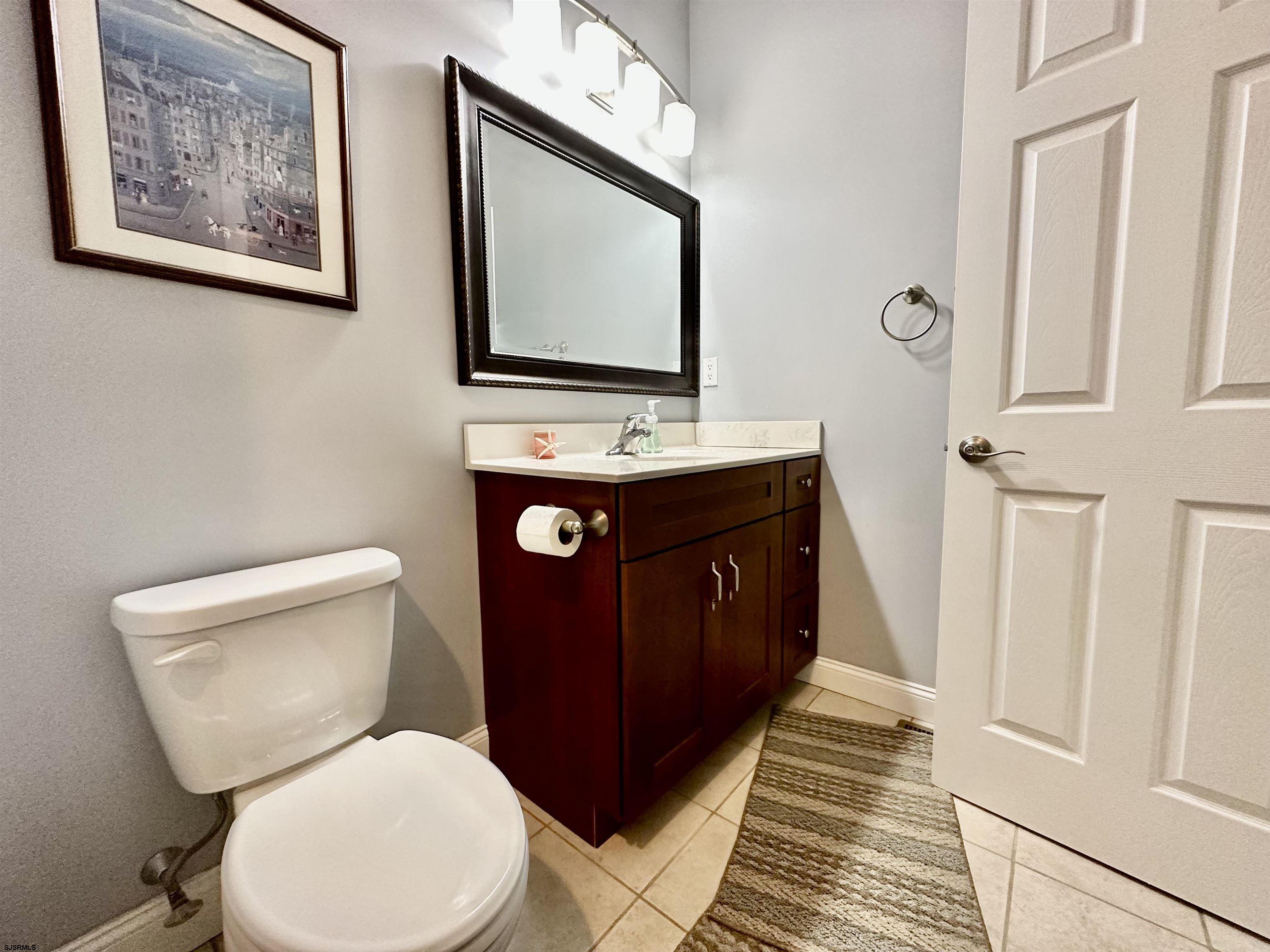 201 19th Street South Brigantine, NJ 08203 - Photo 14 of 29 a bathroom with a toilet sink and mirror