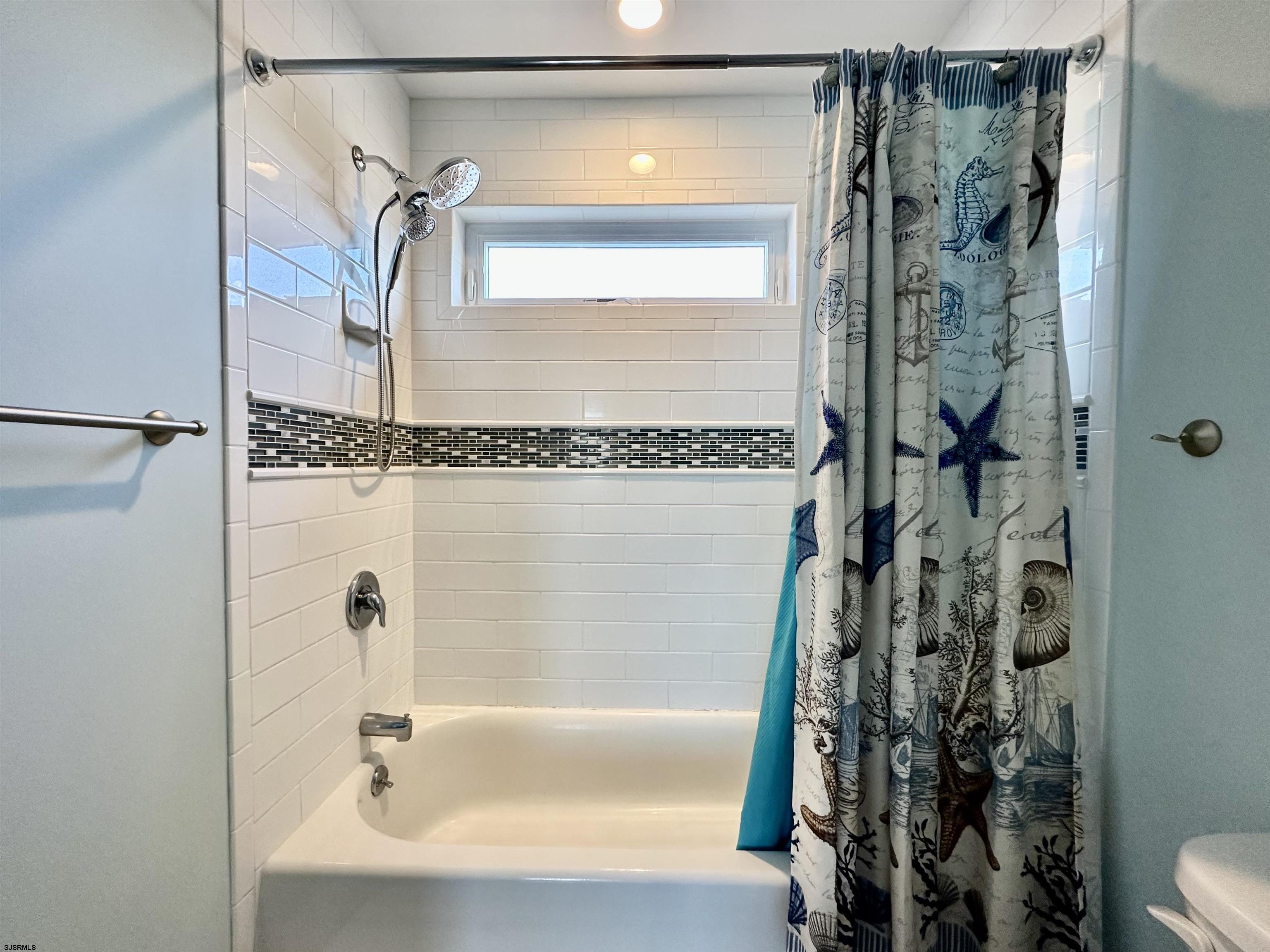 201 19th Street South Brigantine, NJ 08203 - Photo 20 of 29 a bathroom with a shower and a tub