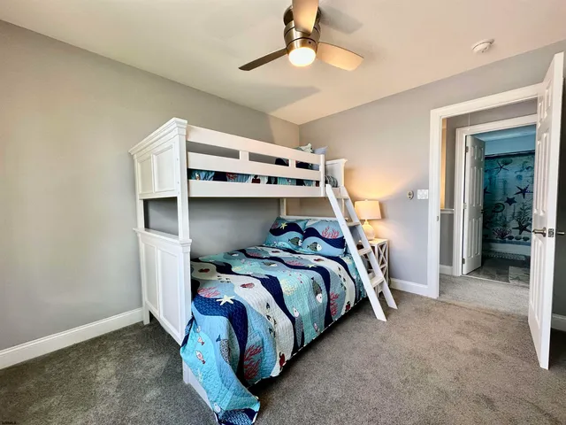 a bed room with a bed and a ceiling fan