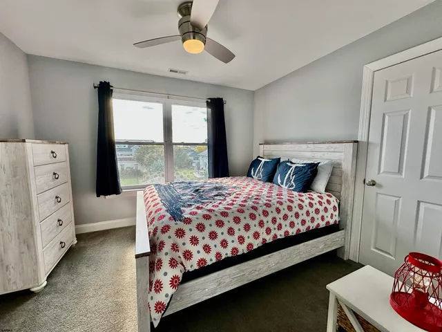 a bedroom with a large bed and a chandelier