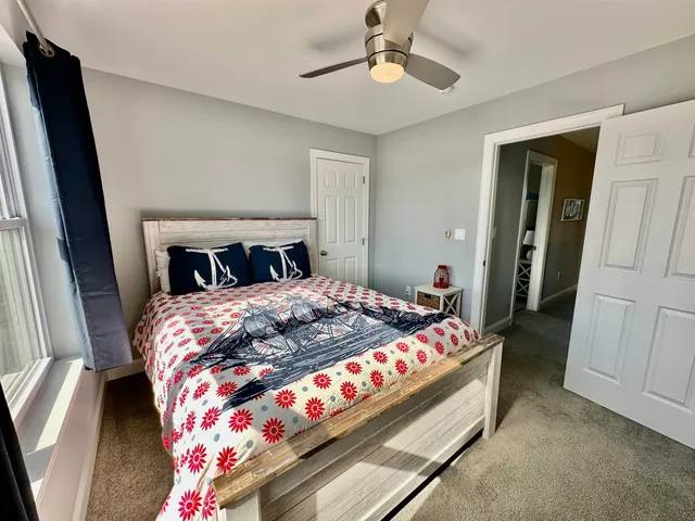 a bedroom with bed and wooden floor