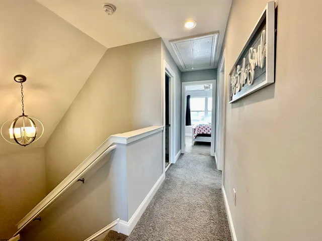 a view of a hallway view with staircase