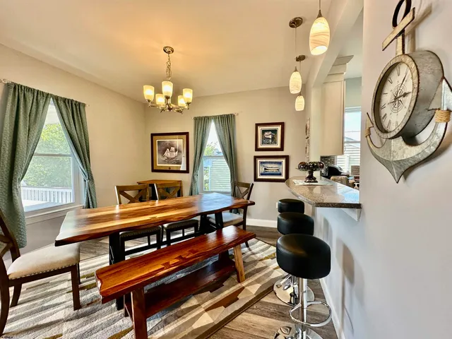 a living room with furniture a clock and a large window