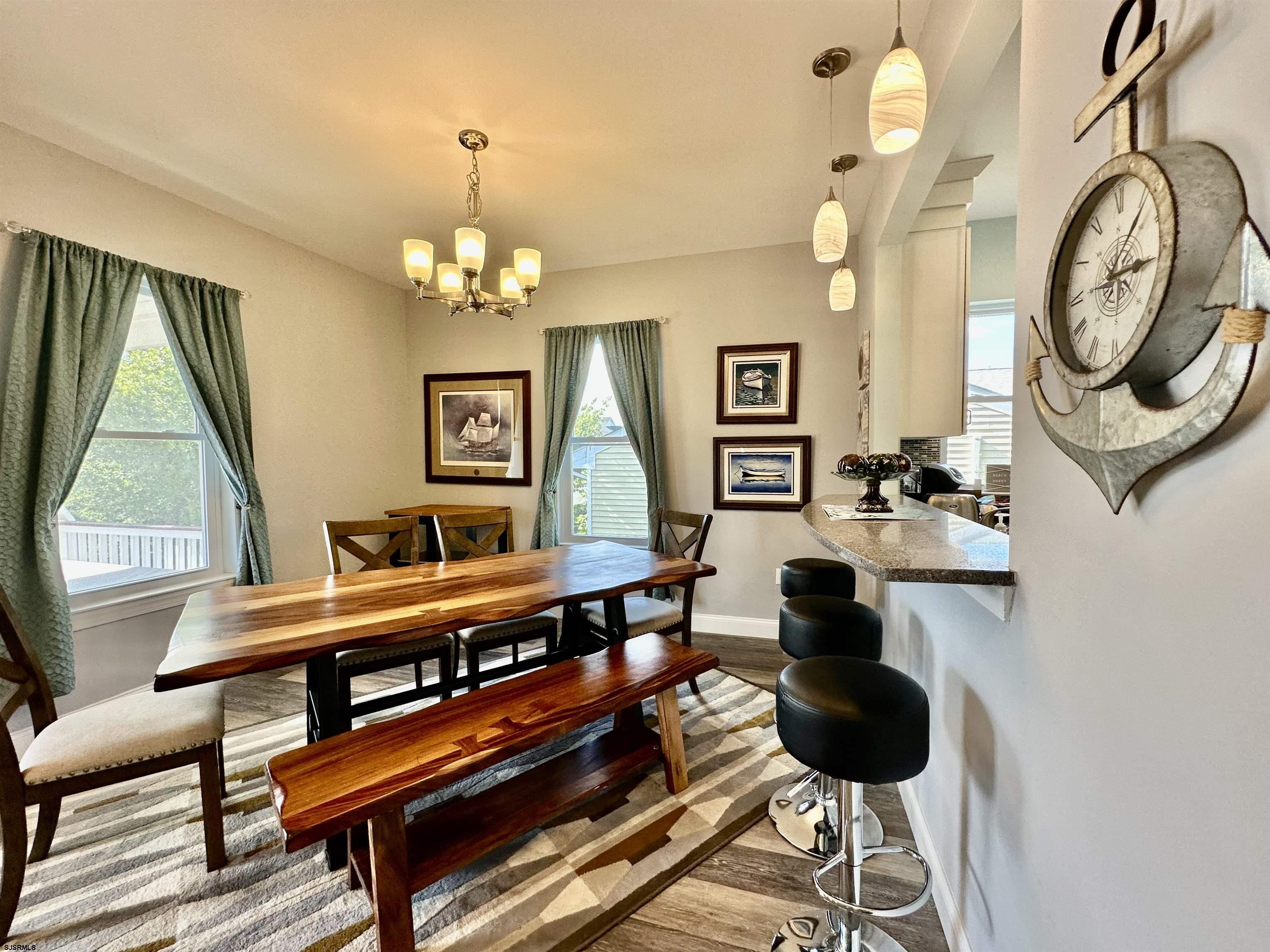 201 19th Street South Brigantine, NJ 08203 - Photo 7 of 29 a living room with furniture a clock and a large window