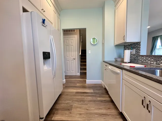 a kitchen with stainless steel appliances a refrigerator and a stove