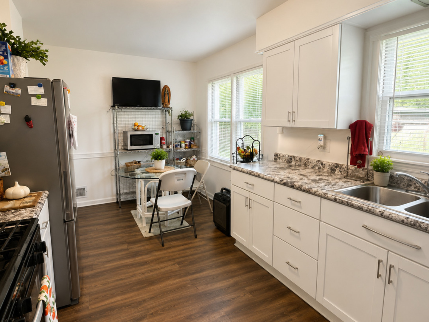 900 Westminster Road Joliet, IL 60435 - Photo 6 of 16 a kitchen with granite countertop white cabinets and white appliances