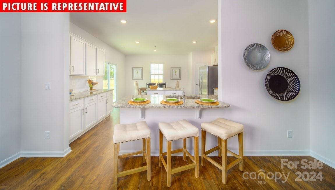 10840 Tuff Lane Davidson, NC 28036 - Photo 9 of 33 a view of kitchen and dining area with chandelier