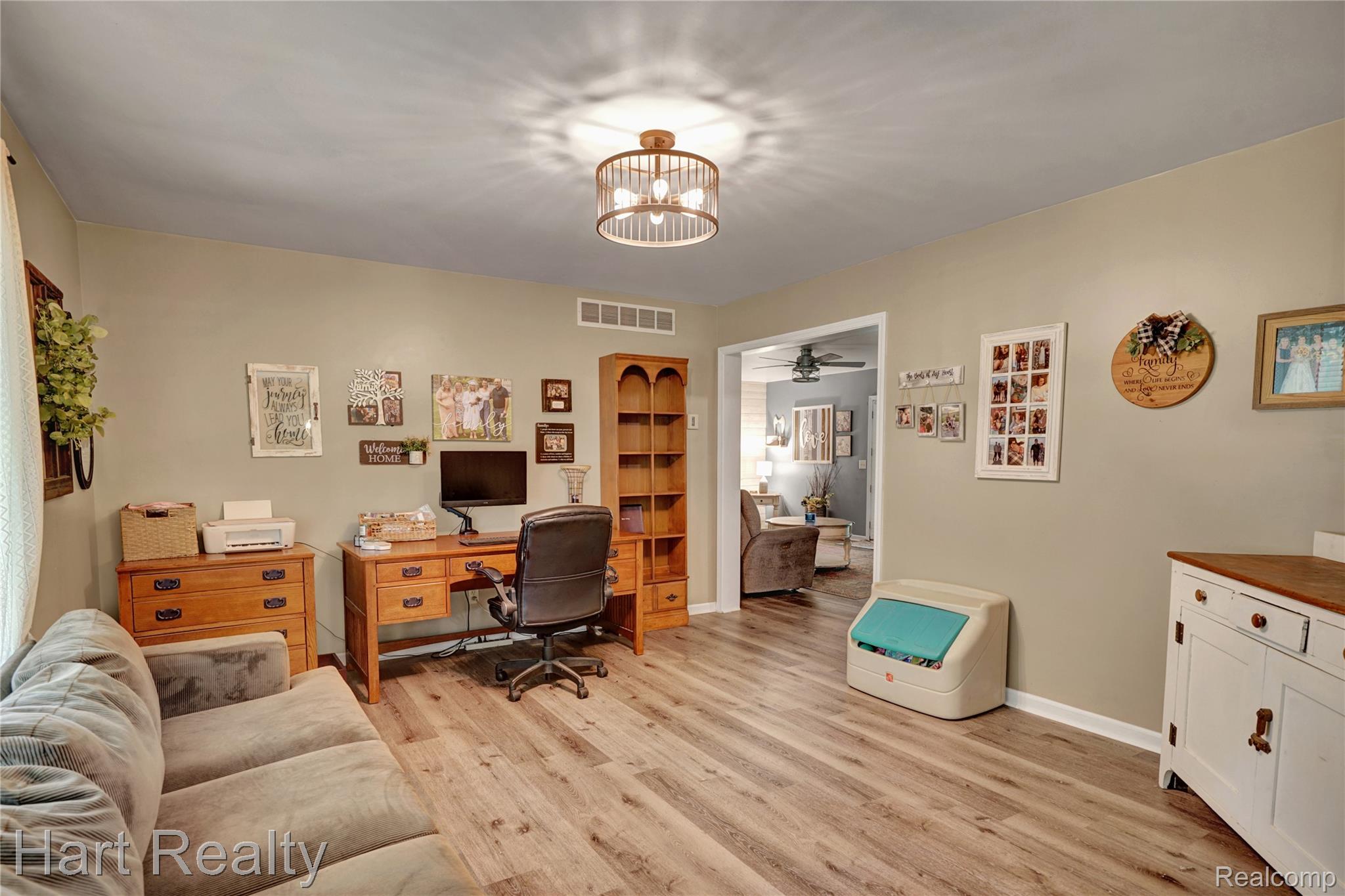 7167 Brown School Road North Branch, MI 48461 - Photo 11 of 51 Spacious room featuring wood-finish flooring, neutral wall tones, and a drum-style flush mount light fixture
