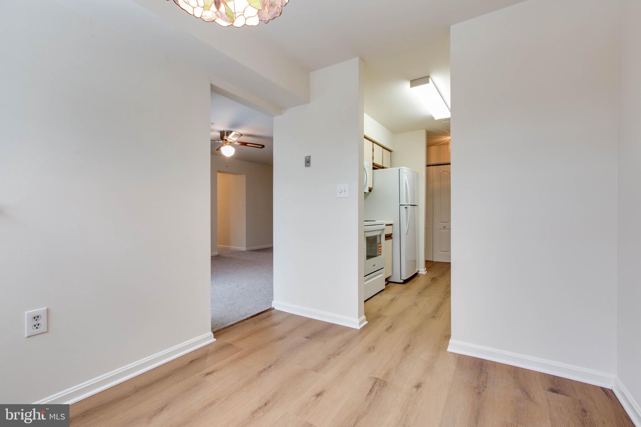 8399 Montgomery Run Road, Unit G Ellicott City, MD 21043 - Photo 14 of 31 an empty room with wooden floor and entrance