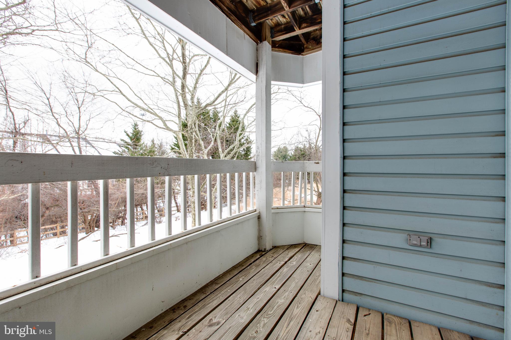8399 Montgomery Run Road, Unit G Ellicott City, MD 21043 - Photo 29 of 31 a view of a balcony with wooden floor
