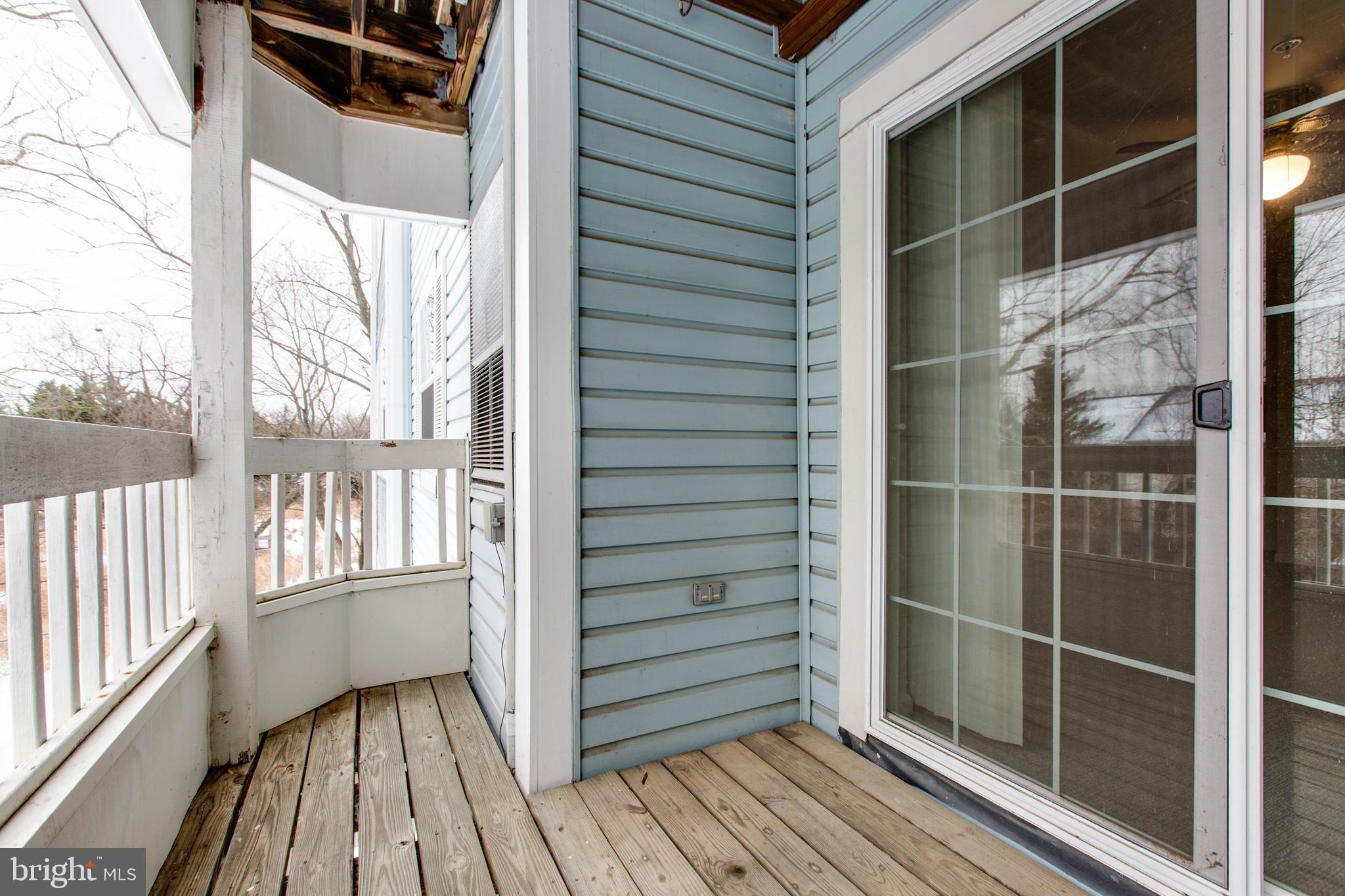 8399 Montgomery Run Road, Unit G Ellicott City, MD 21043 - Photo 30 of 31 a view of a balcony with wooden floor