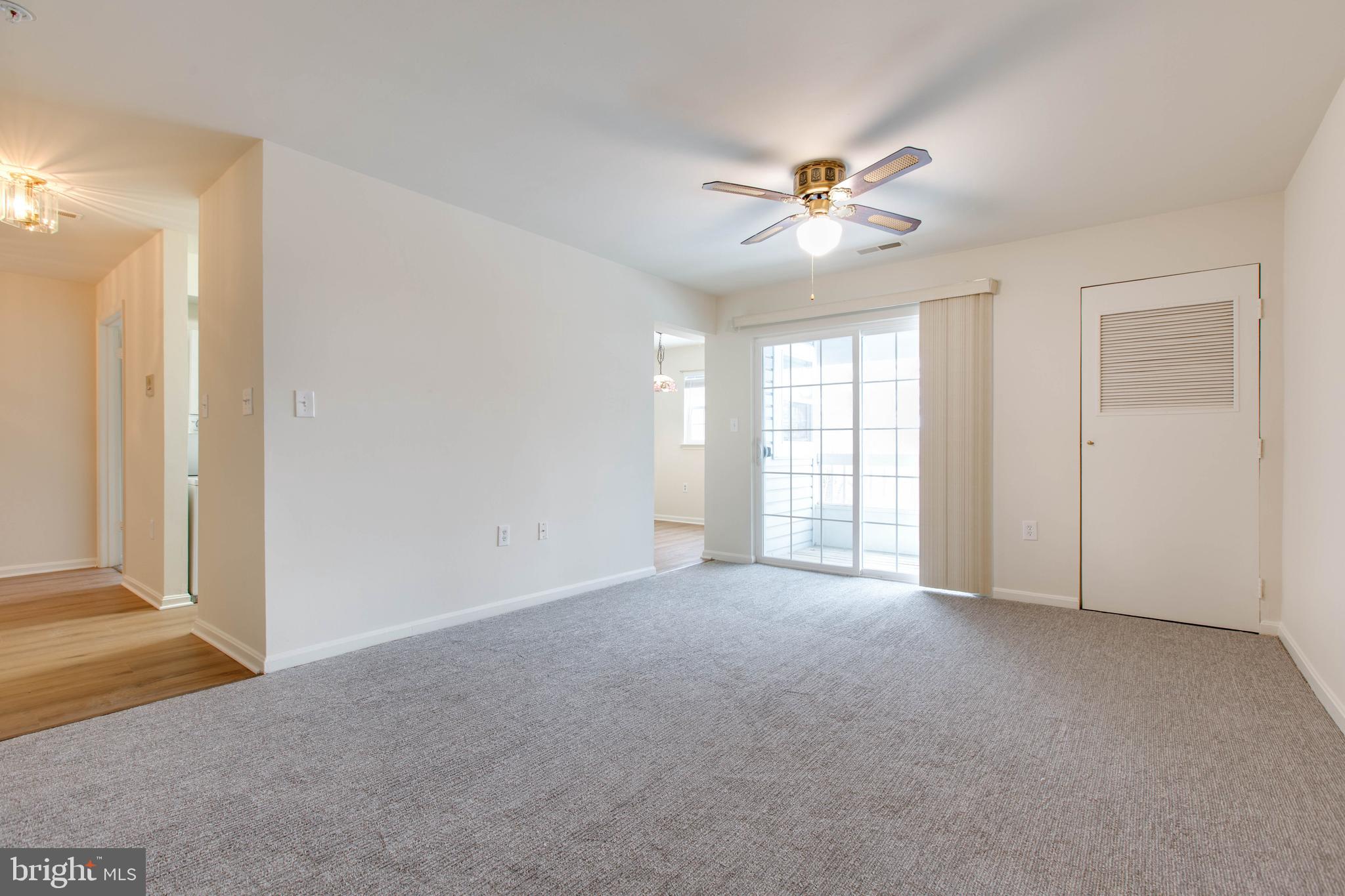 8399 Montgomery Run Road, Unit G Ellicott City, MD 21043 - Photo 9 of 31 a view of an empty room with window and a ceiling fan