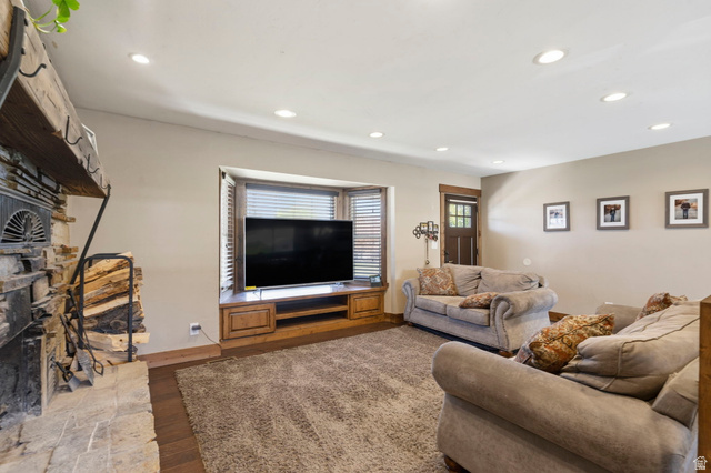 781 West 3000 South Heber City, UT 84032 - Photo 5 of 30 Living area featuring a stone fireplace, dark wood-style floors, and recessed lighting