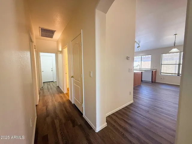 a view of a hallway with wooden floor