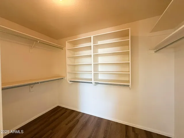 a view of a room with wooden floor and a window