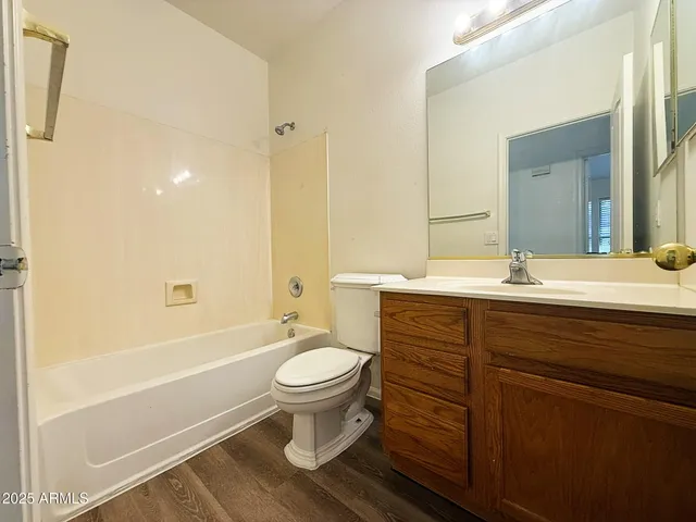 a bathroom with a sink toilet a mirror and shower